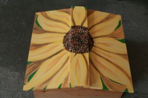 Roof of Warre Hive painted with a sunflower