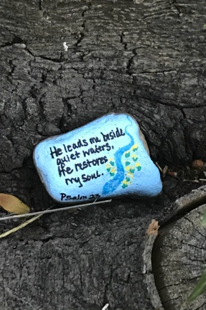 Painted rock by quiet waters