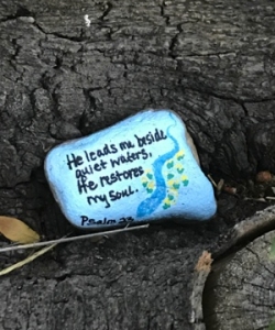 Painted rock by quiet waters