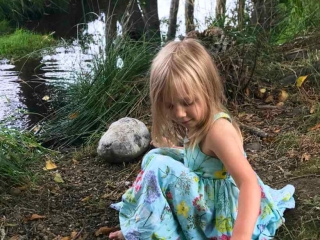Little girl by stream